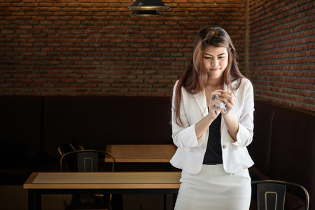 nervous young frustrated business woman screwed up paper in officeの写真素材
