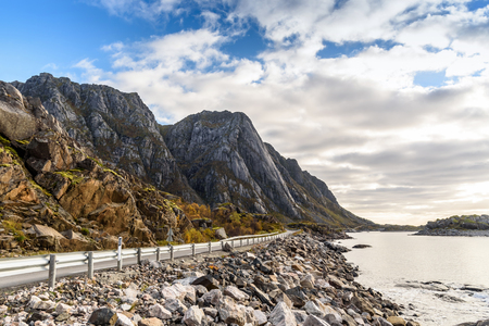 Asphalt road along mountain and sea with blue sky, Norway, selective focusの写真素材