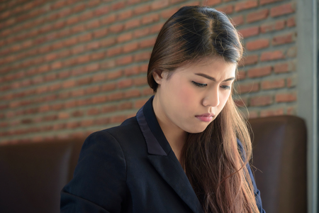 Young depressed stressed frustrated asian businesswoman working at office の写真素材