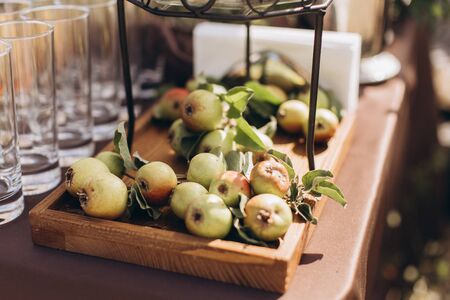 Apples on a wooden tray at a wedding banquet.