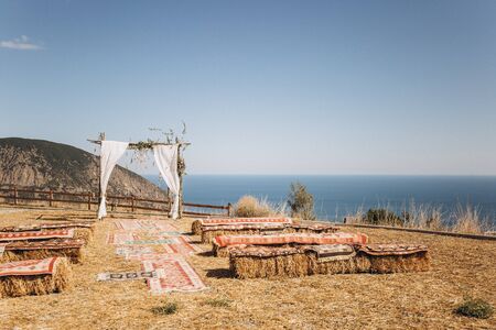 Arch decorated with lively floristics on the background of the sea. Boho styleの写真素材