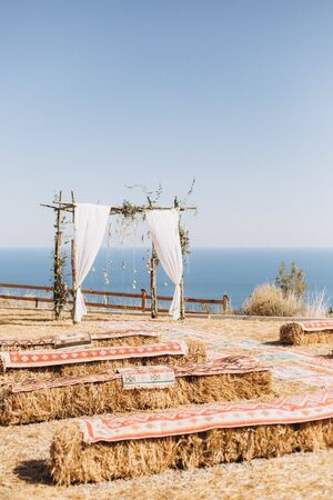 Arch decorated with lively floristics on the background of the sea. Boho styleの写真素材