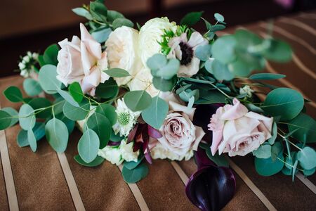 Wedding asymmetrical stylish bouquet with purple rosesの写真素材