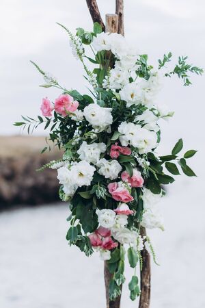 Fragment of a wedding arch for an exit ceremony decorated with white and pink flowers.の写真素材
