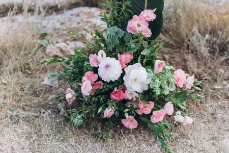 Fragment of a wedding arch for an exit ceremony decorated with white and pink flowers.の写真素材