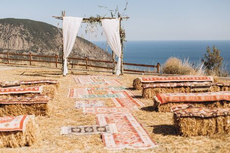Arch decorated with lively floristics on the background of the sea. Boho styleの写真素材