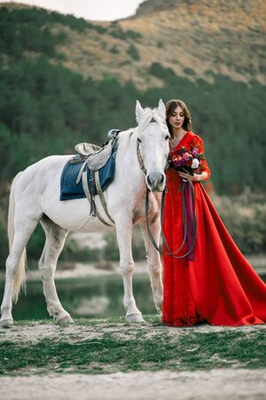 Princess in a red dress from a fairy tale.の写真素材
