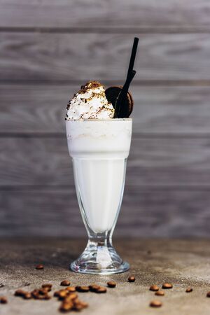 Delicious cold milkshake with cocoa and chocolate in a glass.の写真素材