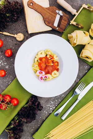 Pasta made of spaghetti on a gray background with decorations for advertising the menu.の写真素材
