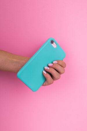 Smartphone in a mint case on a pink background.