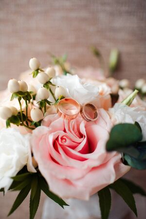 Pale pink bridal bouquet with delicate pink flowers with rings.の写真素材