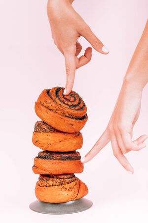 Sweet, warm buns with poppy seeds on a pink background. Muffins.の写真素材