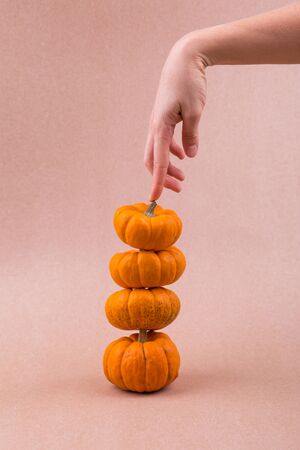 Four mini pumpkins for Halloween with hand. Decor.の写真素材