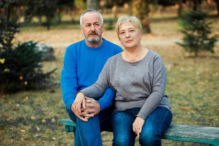 Elderly couple walks in the park. Happy old age.