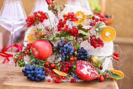 Autumn bouquet of pomegranate, orange, apples.の写真素材