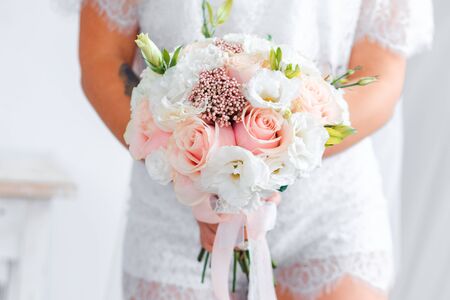 Delicate classic wedding bouquet of roses for the bride. Wedding flowers.