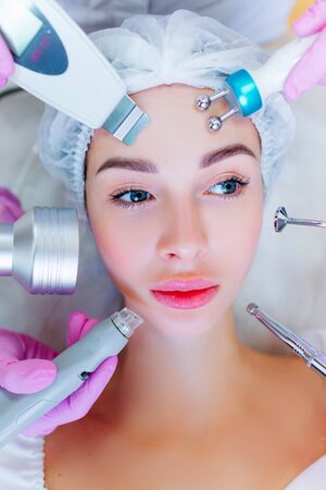 Hardware skin care. A young girl cares for her face. Beauty treatment. Procedures. Advertising.