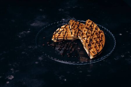 Waffles with chocolate on a concrete gray background.の写真素材