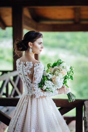 The bride in a magnificent, white, wedding dress with a wedding flowers.の写真素材