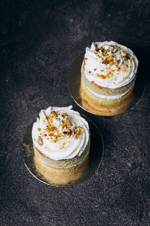 Cakes with white cream and on a black background. Baking and sweets. Baking and sweets.- Imageの写真素材