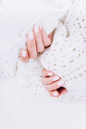 Stylish trendy white manicure. Tender female hands.の写真素材