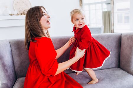 Mom and daughter in a bright apartment or house.の写真素材