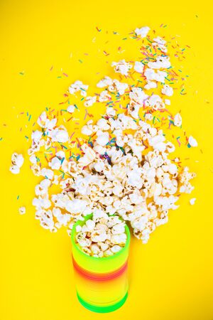 Scattered popcorn on a yellow background. Abstraction and minimalism.の写真素材