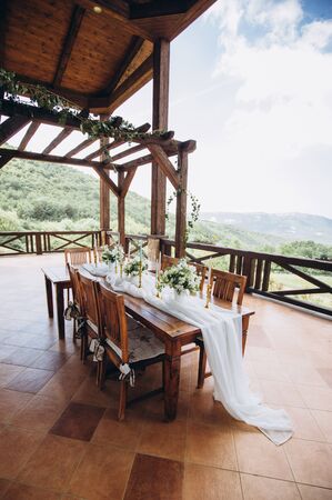 Wedding table for a newlywed banquet with eco decor and floral design in the style of boho.