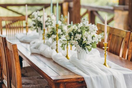 Decorated wedding table for the newlyweds and guests with mountain views. Wedding decor and Floristics.の写真素材