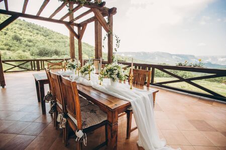 Decorated wedding table for the newlyweds and guests with mountain views. Wedding decor and Floristics.の写真素材