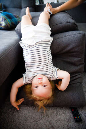 Little kid girl indulges in the couch.の写真素材