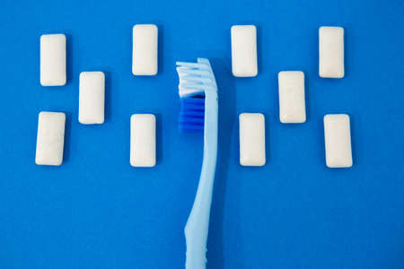 Blue toothbrushes on a blue background. Protecting teeth from caries.の写真素材