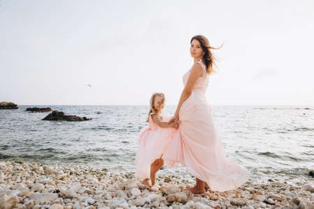 Mother and Daughter in pink dresses. Family.の写真素材