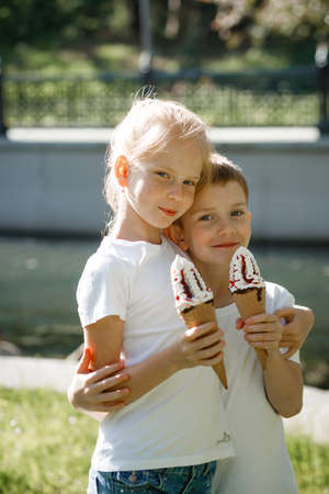 Children eat ice cream in the park.の写真素材