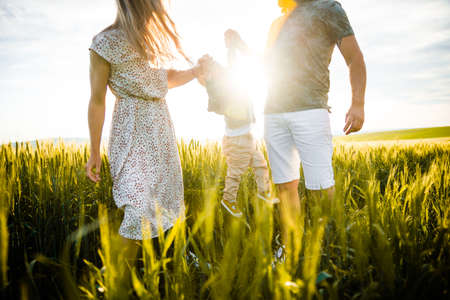 Happy family in nature. Mother, father and son in nature.の写真素材
