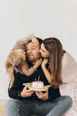 Family celebrates the birthday of their little daughter.の写真素材