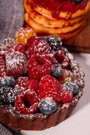 Fresh cake with raspberries in powdered sugar. Dessert in a cafe for breakfast.の写真素材