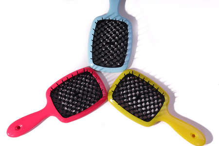 Multi-colored hair combs on an isolated white background.の写真素材