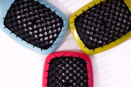 Multi-colored hair combs on an isolated white background.の写真素材