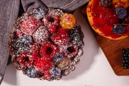 Fresh cake with raspberries in powdered sugar. Dessert in a cafe for breakfast. High quality photoの写真素材