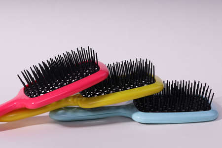 Multi-colored hair combs on an isolated white background.の写真素材