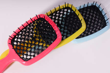 Multi-colored hair combs on an isolated white background.の写真素材