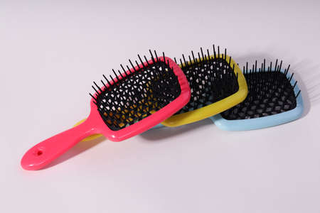 Multi-colored hair combs on an isolated white background.の写真素材