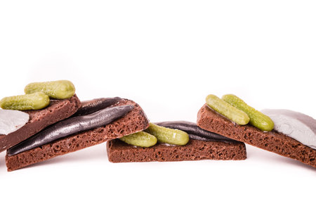 Sandwich with fish and lightly salted cucumbers on black bread.の写真素材