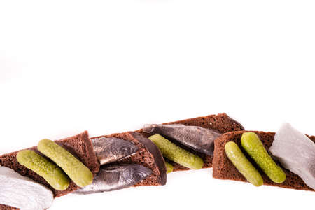 Sandwich with fish and lightly salted cucumbers on black bread.の写真素材