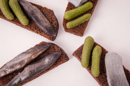 Sandwich with fish and lightly salted cucumbers on black bread.の写真素材