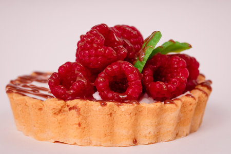 Fresh cake with raspberries in powdered sugar. Dessert in a cafe for breakfast.の写真素材
