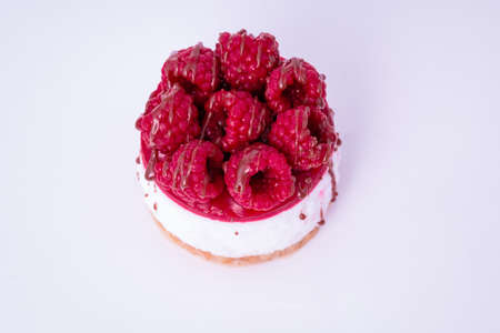 Fresh cake with raspberries in powdered sugar. Dessert in a cafe for breakfast.の写真素材