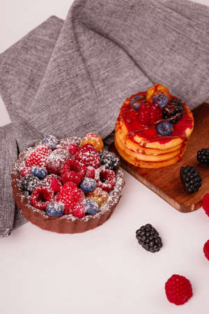 Fresh cake with raspberries in powdered sugar. Dessert in a cafe for breakfast.の写真素材