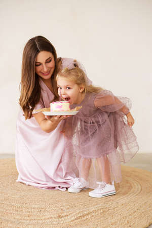 Child is emotionally eating a birthday cake. Birthday celebration.の写真素材